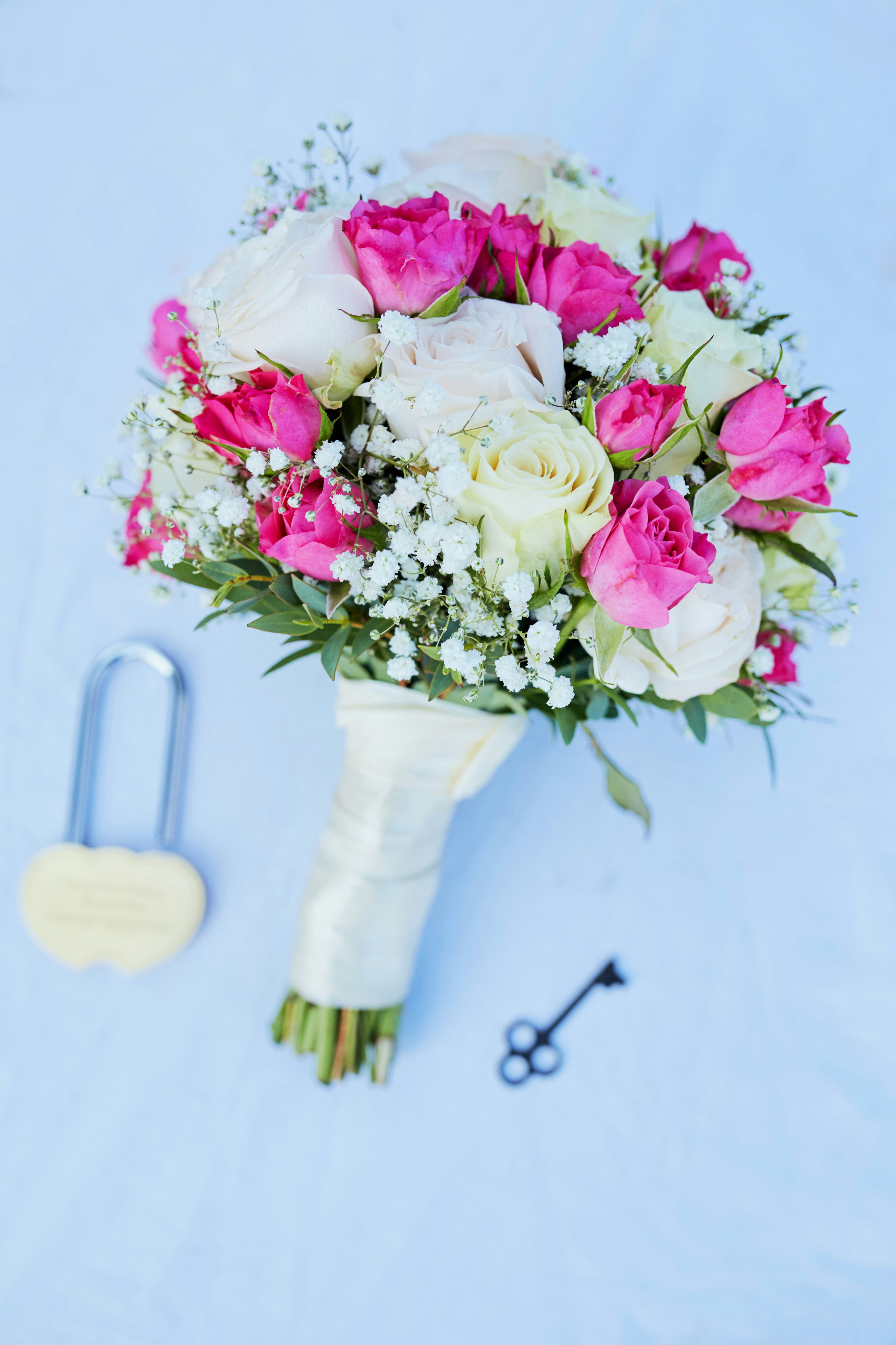 pink and white roses in white ceramic vase